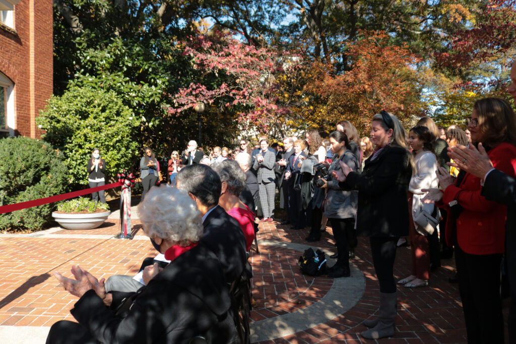 Photo of people gathering around to watch the renaming of Meigs Hall ceremony