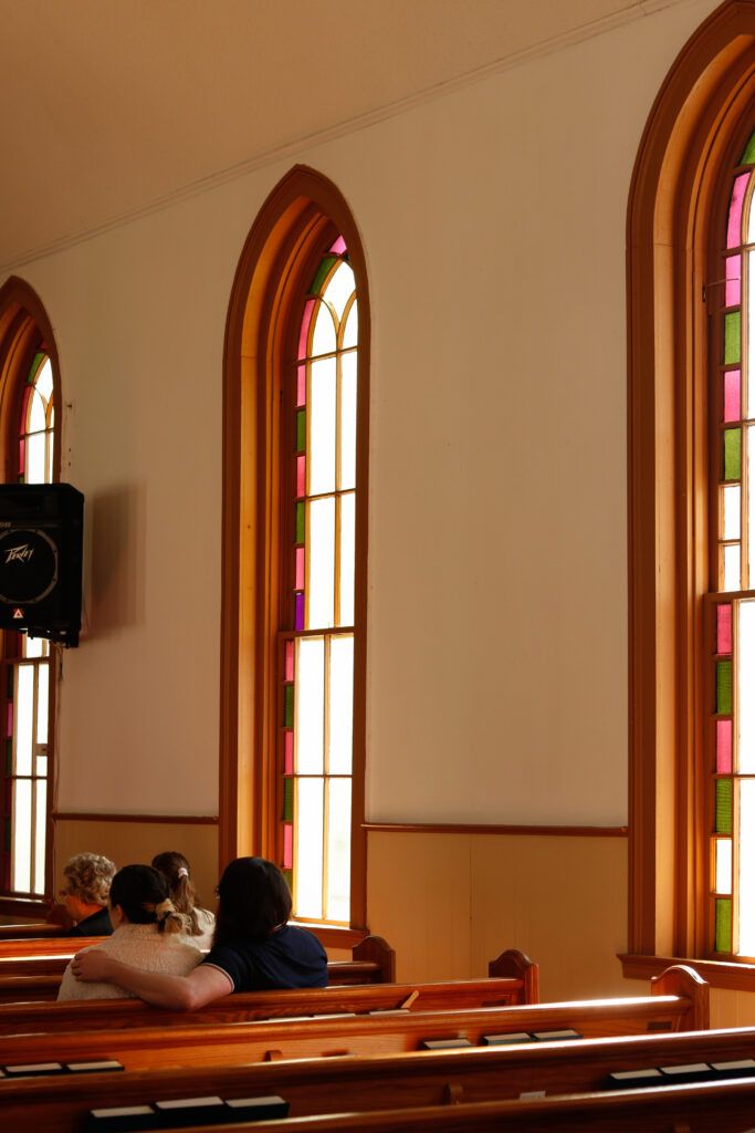 Photo of A couple listening to the service in the church pews at Crawford Baptist Church in Oglethorpe County on Sunday, March 27, 2022.